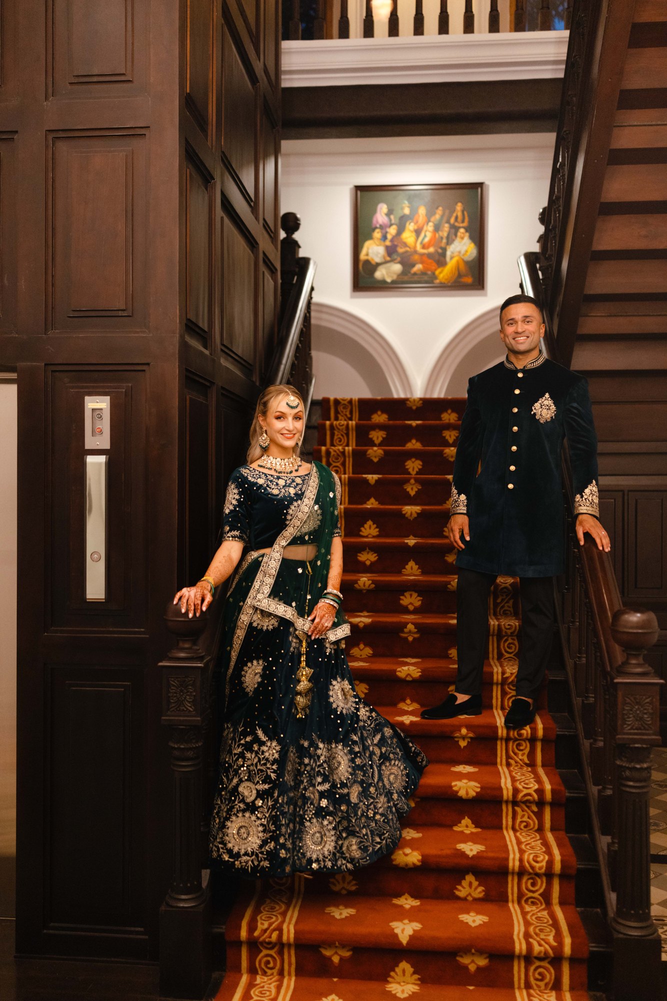 Newlyweds together on a grand staircase