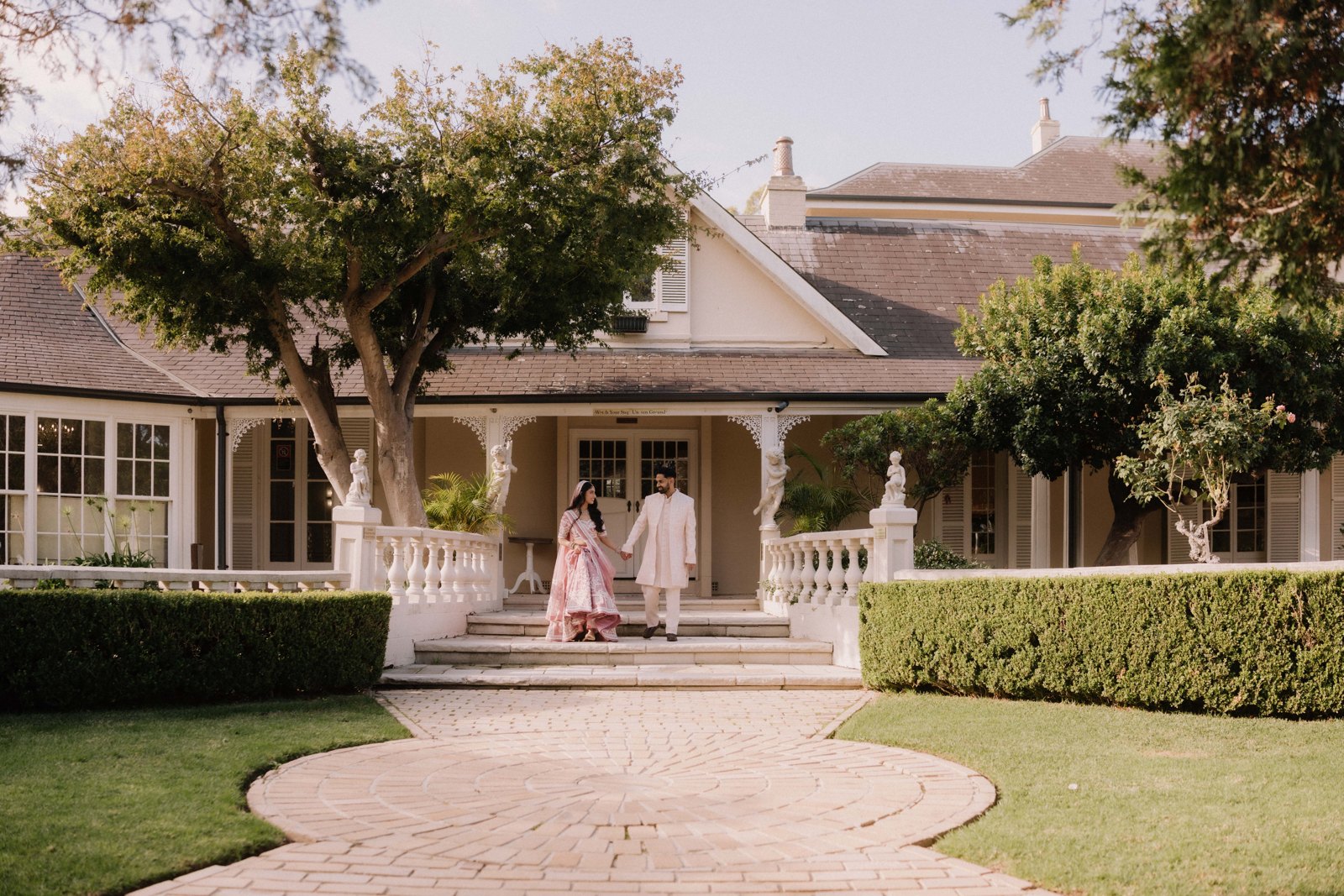 A couple outside a garden estate