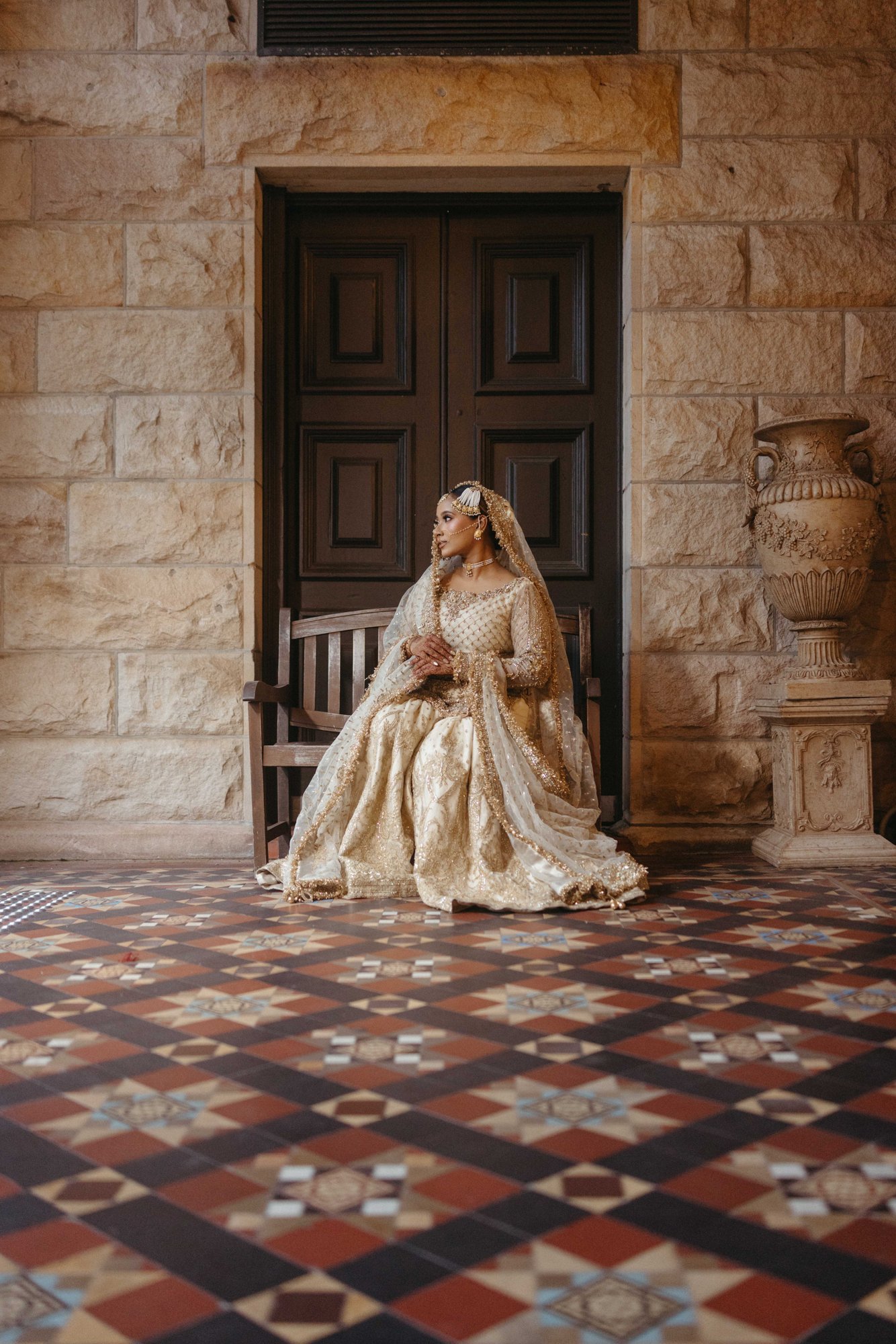 A bride standing in a stone courtyard
